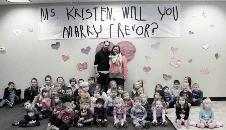 Trevor surprised Kristen when she thought she was going to a meeting at work. When she walked in he had her kids shout, Ms. Kristen will you marry Trevor? and she said yes. 