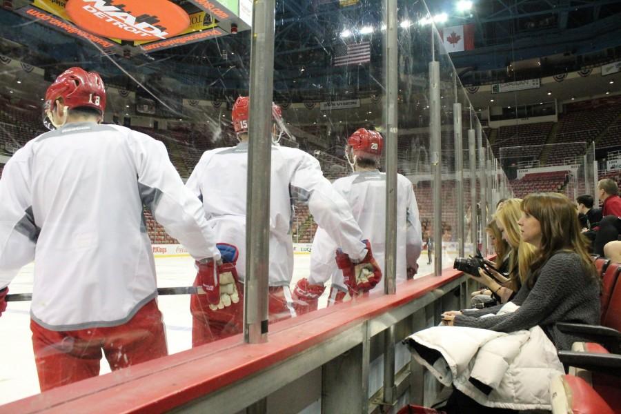 Up close and personal. Journalist are able to action shots of the Red Wings practice on February 13. Players Joakim Andersson (#18), Riley Sheahan (#15), and Drew Miller (#20) stand just inches away from high school journalists gathered for the the Journalist day at the Joe Louis Arena.  