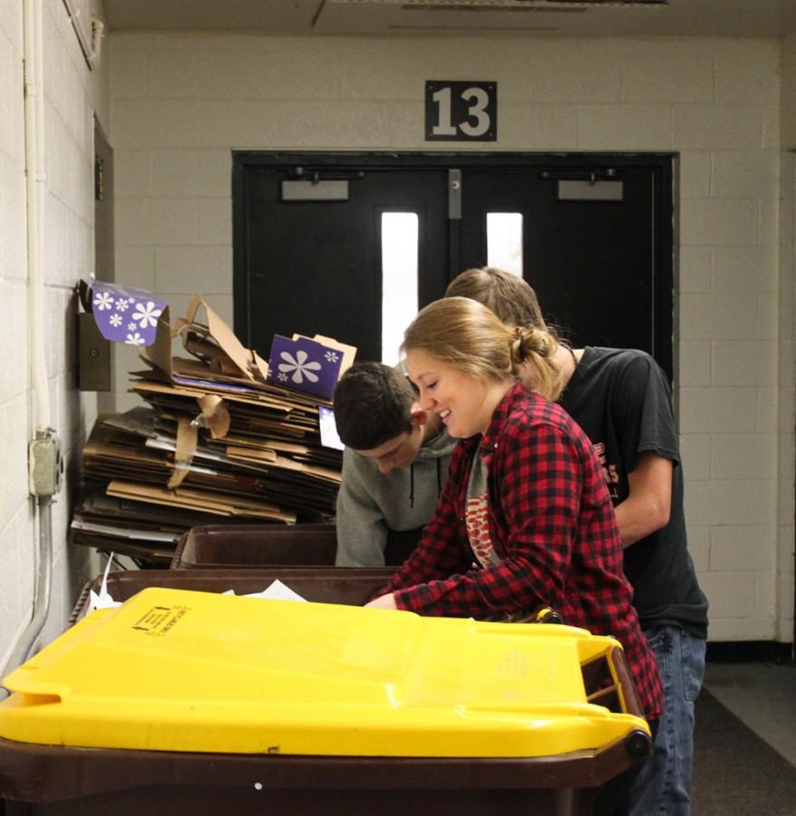 Taking care of the classroom’s recycling, leadership students Amanda Page 12, Elijah Huebner 12 and Liam Corby 11 put the recyclables into bins to be shipped off to Granger on November 30th, 2015.