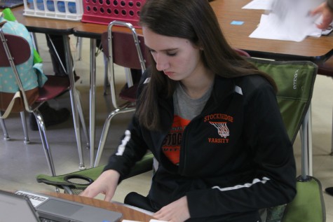 Focusing on this year's book, senior McKenzie Carpenter looks over some spreads of future pages.