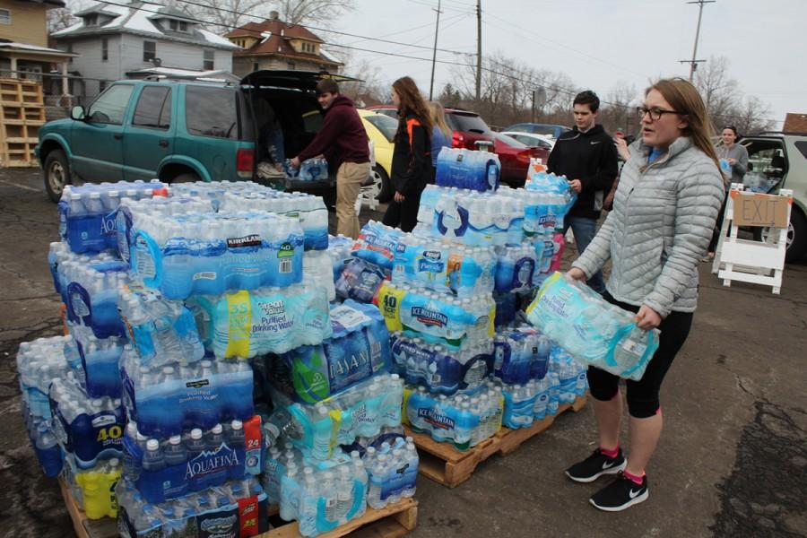 Unloading donated water, senior Amanda Page, member of the National Honor Society, helps take water to Flint to assist the community members with the water crisis. 