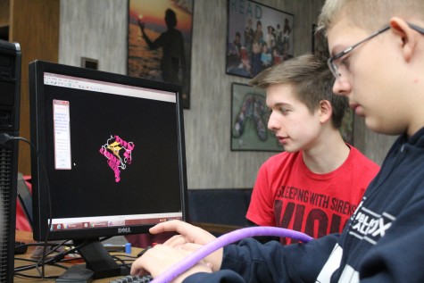 Examining the structure of a protein using a digital program, freshmen Shane Adams and Derek Young work to accurately represent the turns and bends in their biological molecule.