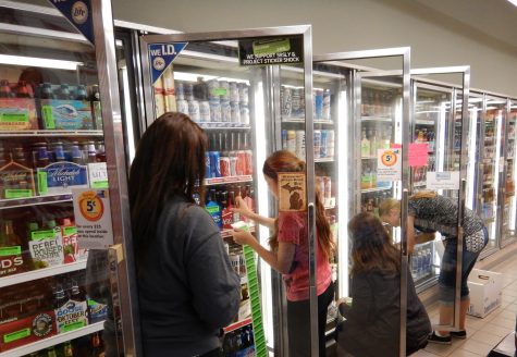 Local middle and high school students label alcoholic beverages at the Shell gas station on Main Street, an event they call Project Sticker Shock. SRSLY prints off hundreds of stickers to warn parents that buying alcohol for minors is illegal and punishable by jail time or first. Pictured Erin Stewart, adviser Emily Stewart, and freshman Hannah Bolton.