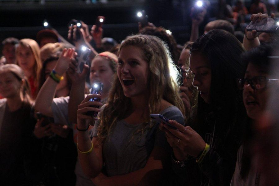 Illuminating faces among the crowd with cellphone flashlights, the audience sings along to the winning song of the twitter poll, Journeys Dont Stop Believing,” wrapping up the conference. 