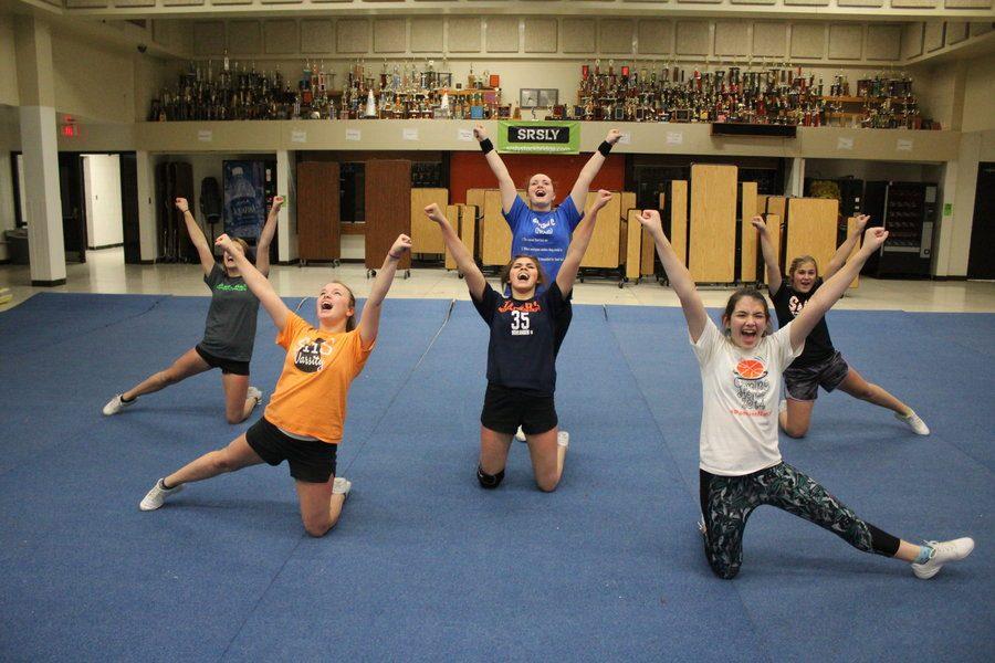 After rolling out the mats, and completing their stretches and warm ups, the competitive cheer team works on perfecting their routines for their upcoming competition.
