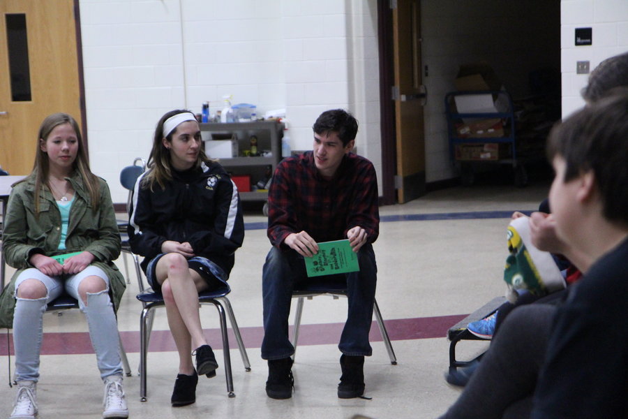 Kaitlin Miller, Savannah Torrey and Ethan Jones, the main characters of Blather, Blarney and Balderdash, sit facing the supporting characters while they run lines from Act 1, Scene 2 for the first time together without their scripts on March 1. Photo 