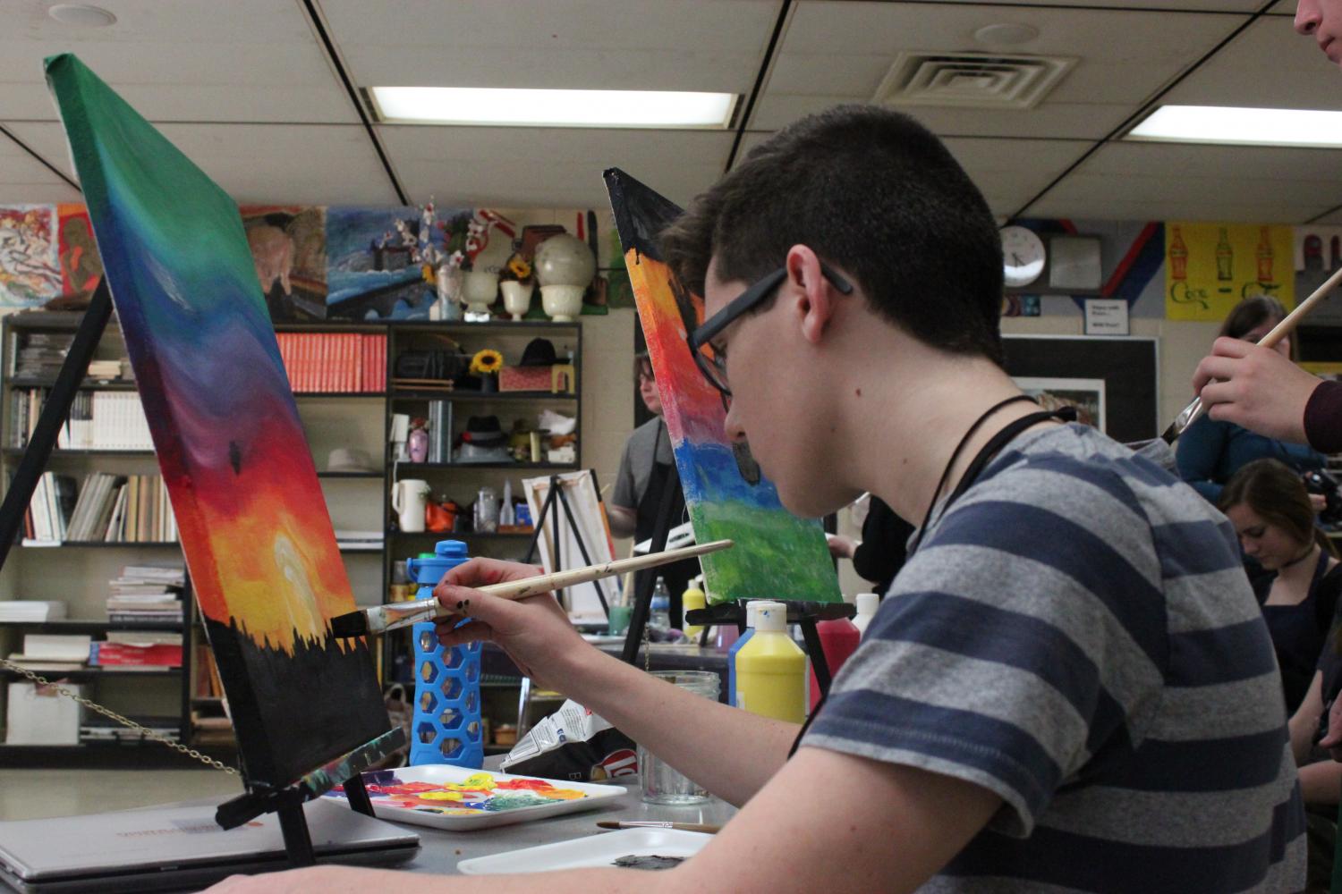 Andrew Carriero begins to paint one of his trees for the background of his painting.