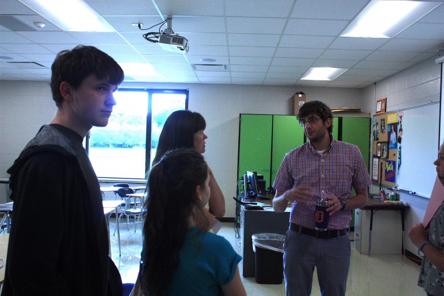 Math instructor, Mr. Rickli talking to students at open house.