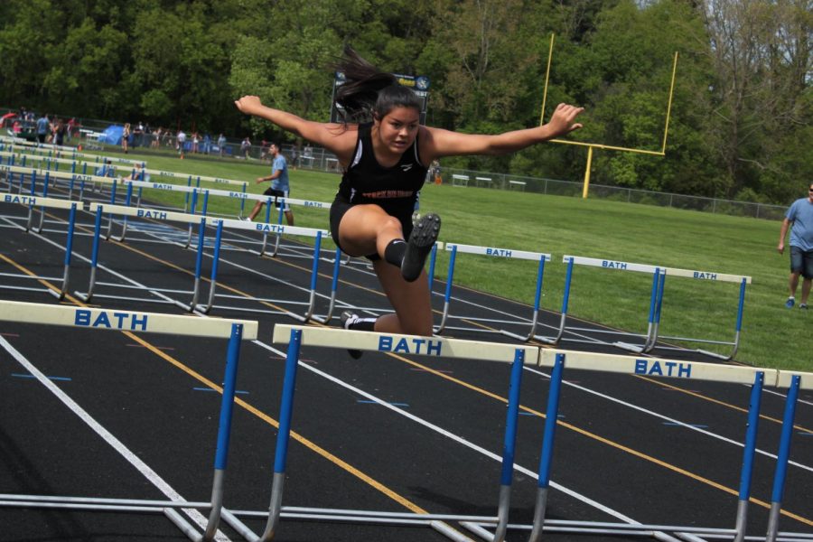 At Regionals, hurdler Elysia Media competes in the 100-meter hurdles, finishing with a time of 20.30. 
