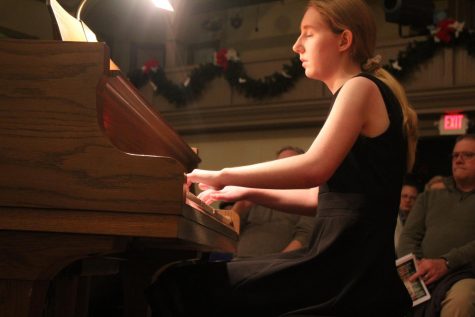 Junior performs on the piano at holiday show