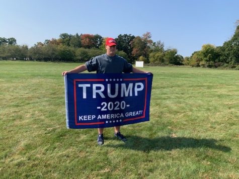 Showing off his flag in front of Stockbridge High School’s apple orchard, Drew Davis 12 represents who he wants to win the 2020 presidential election. Davis thinks that Donald Trump is the best fit for the presidency for the next four years.