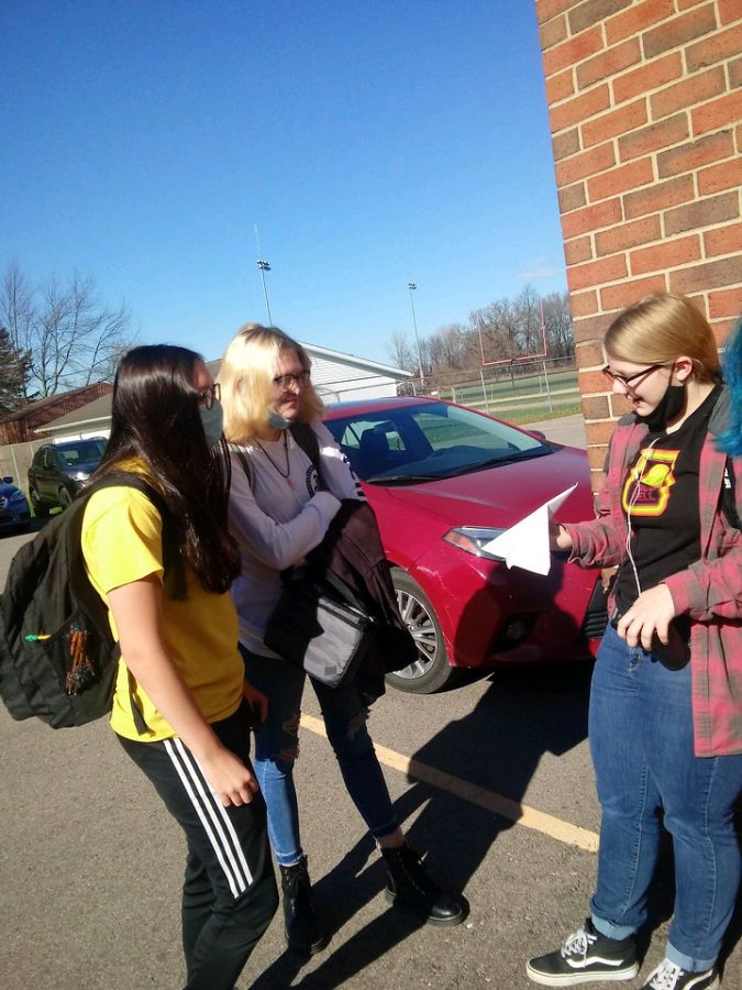 On a rare warm day in November, Marissa Goble, Jacey Gustafson and Tierney Hackworth, outside for mask breaks between classes.