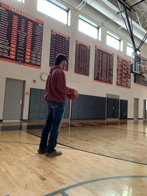 Noah Robidou, 12, practices shooting at Stockbridge High School. The clock is running out not on the scoreboard, but time for the season. The basketball season starts on February 21st 2021. 