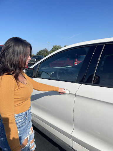 Senior Paige Stolarz getting into her car in the school parking lot. Driving herself to school everyday and paying for her own gas, she regularly deals with the higher gas prices.
