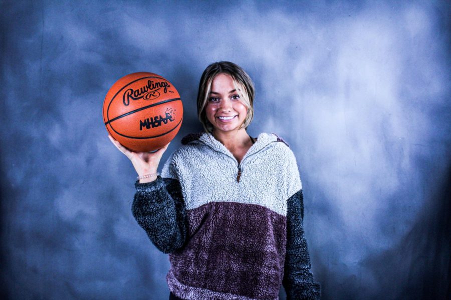 Sophomore Gracee Robidou holds a basketball as she poses for her picture. This is Robidous first year on varsity.