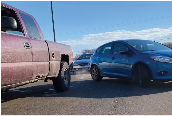 Student attempting to parrallel park, an often difficult and nerving parking method taught in drivers training.