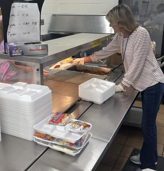 During lunch time, Stephanie White makes sure all of the students have the proper amount of nutrients when she serves the students their food.