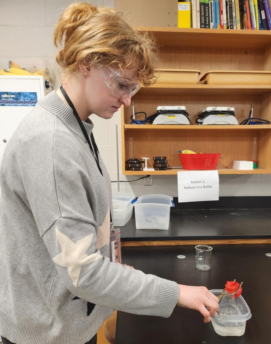 Abby Nicholson tests out a future lab project the students will work on to learn about gas laws. 
