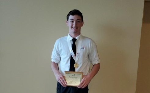 Senior Zach Fletcher holds his first place plaque in Plumbing won from the State Leadership and Skills Conference.  Photo provided by Wilson Talent Center Facebook page