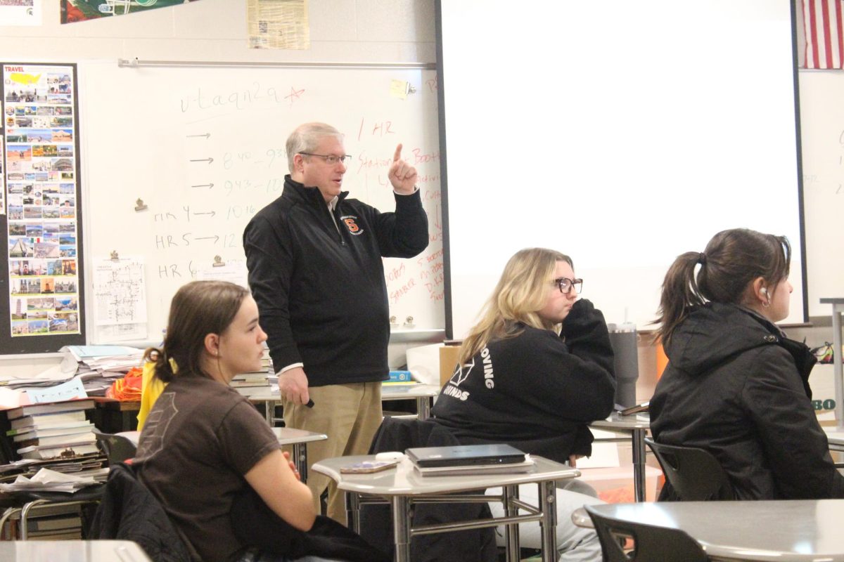 Mr.Baird discusses the upcoming half day plans with his seniors Leadership class. 