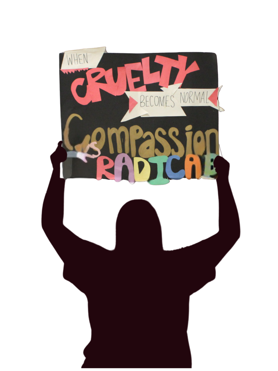 A demonstrator holds her handmade sign reading "When cruelty becomes normal, compassion looks radical." The message conveyed the concerns of many participants who called for greater empathy.
